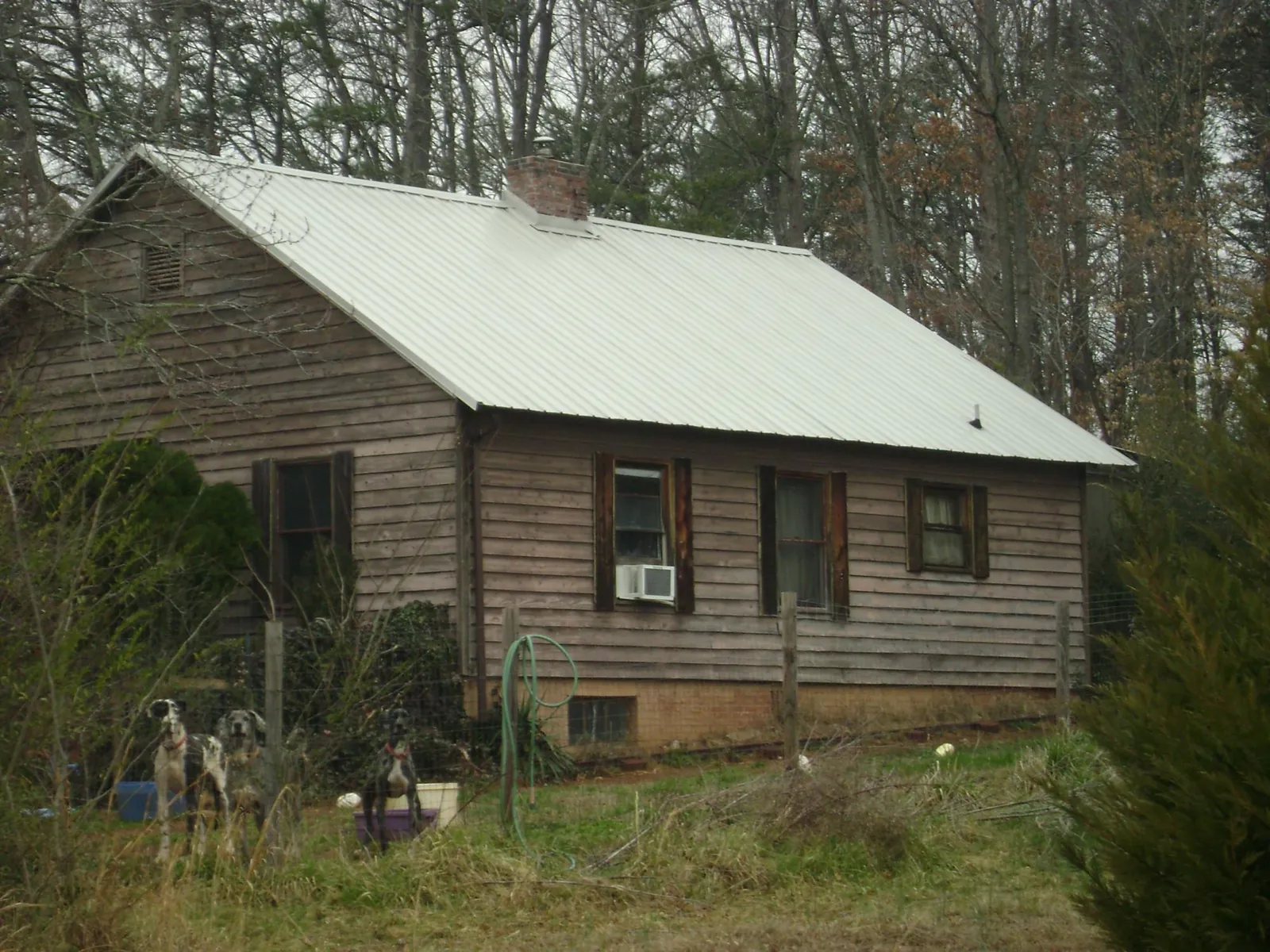 White metal roof on an old wood sided farmhouse, from a Metal Roof Installation job in Diablo